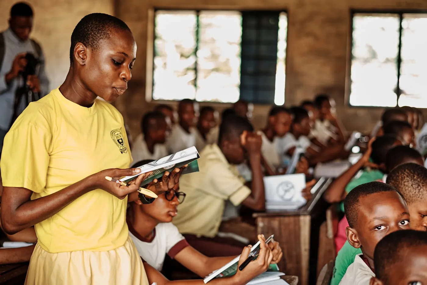 A teacher reading to a classroom of primary school pupils