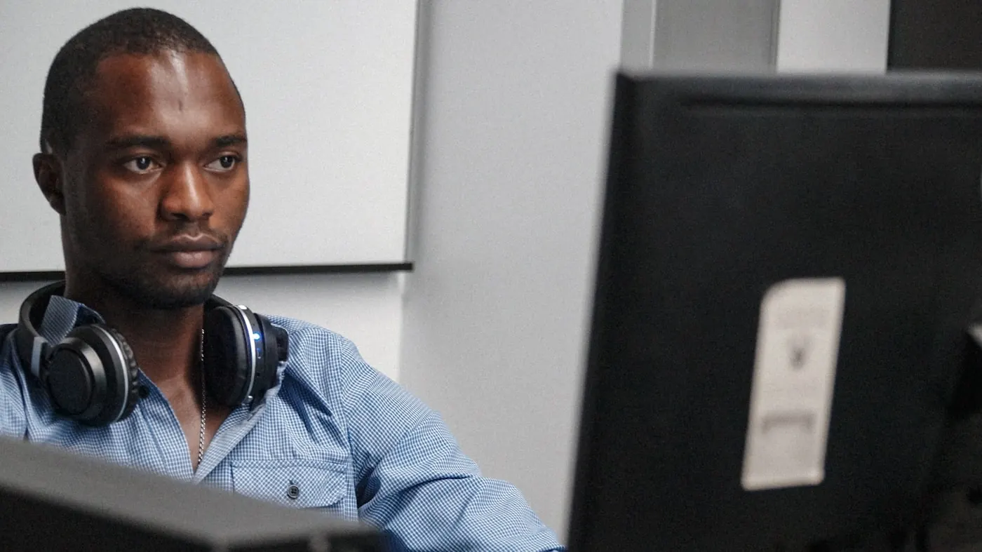 A researcher reviewing project data on a computer monitor